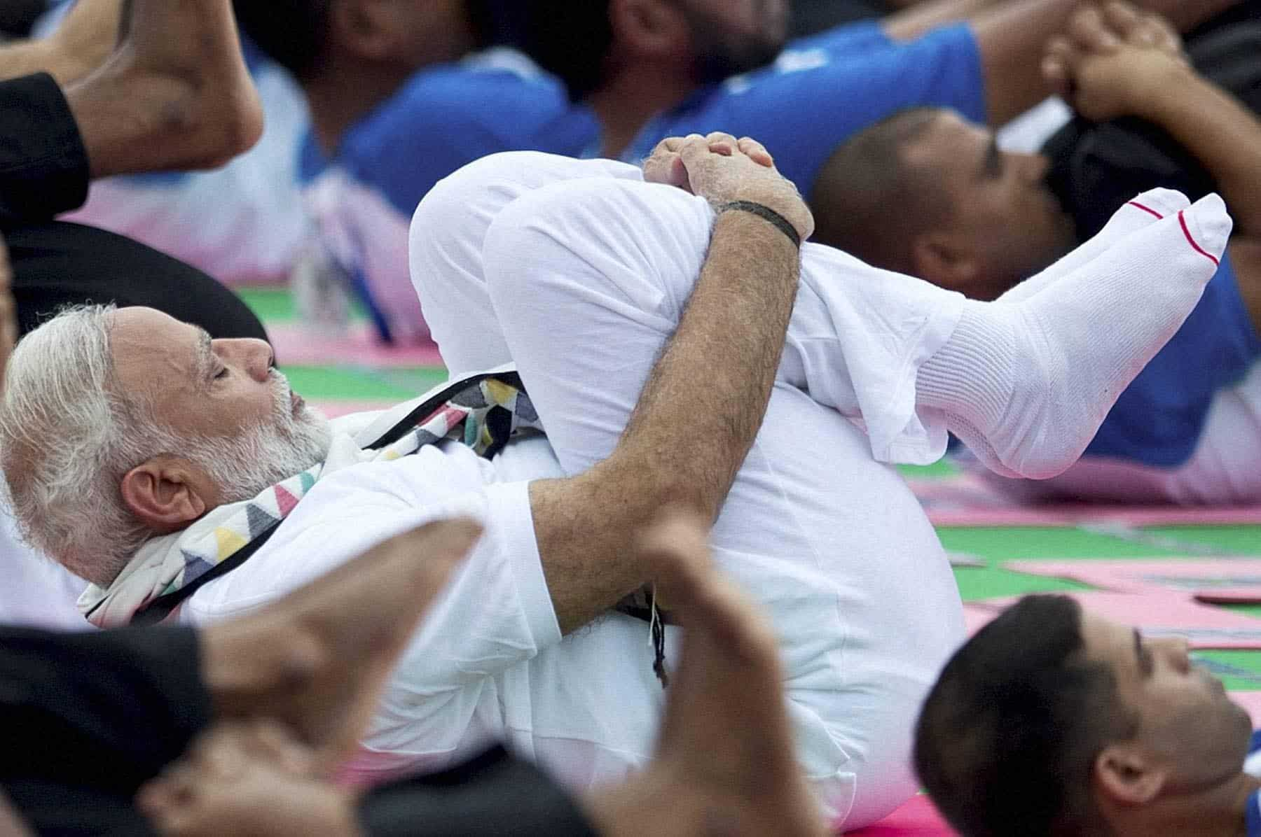 Getting into the yoga routine, PM Modi, along with thousand practitioners. PTI