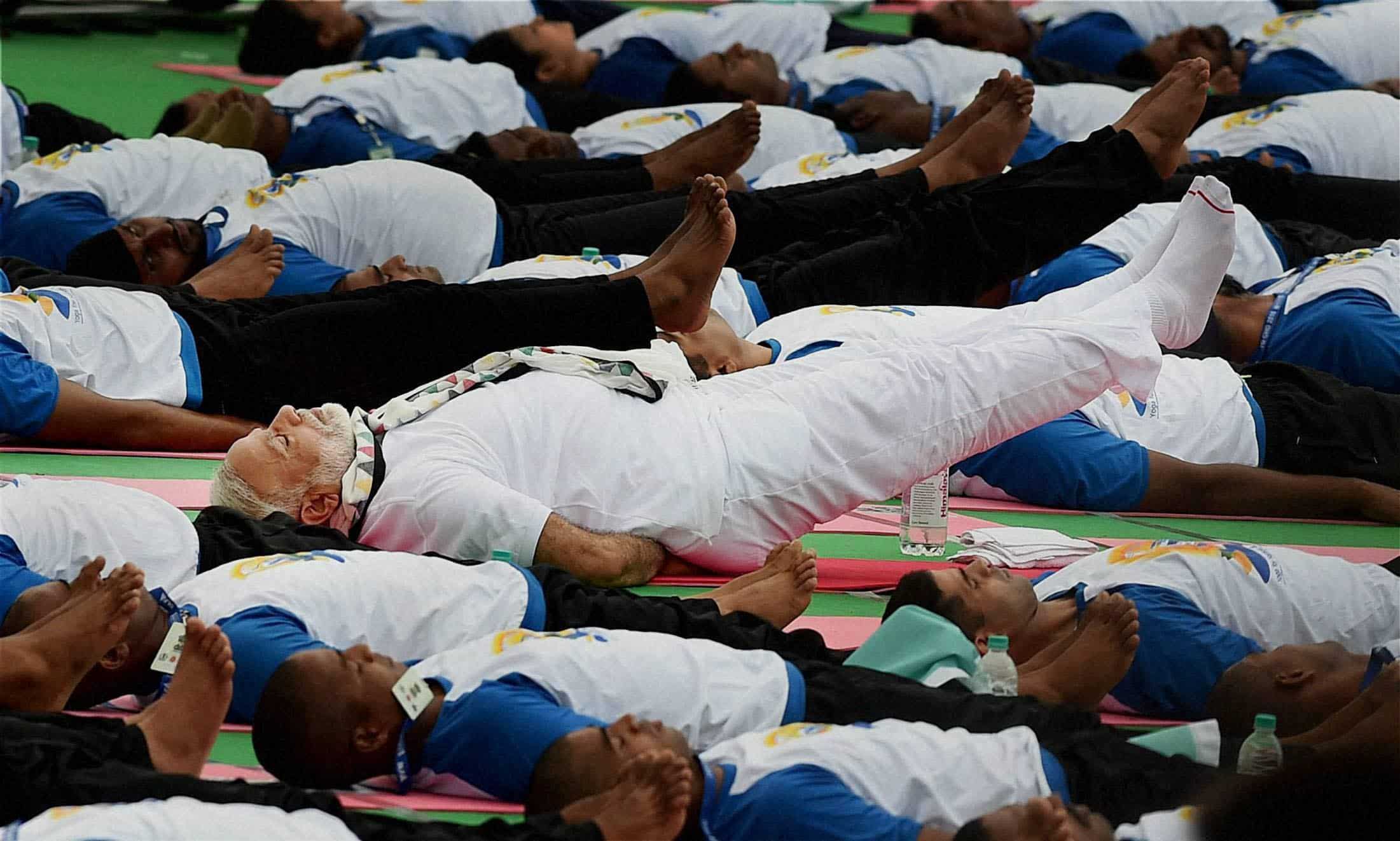 Standing out from the crowd, PM Modi all dressed in white takes part in mass yoga event. PTI