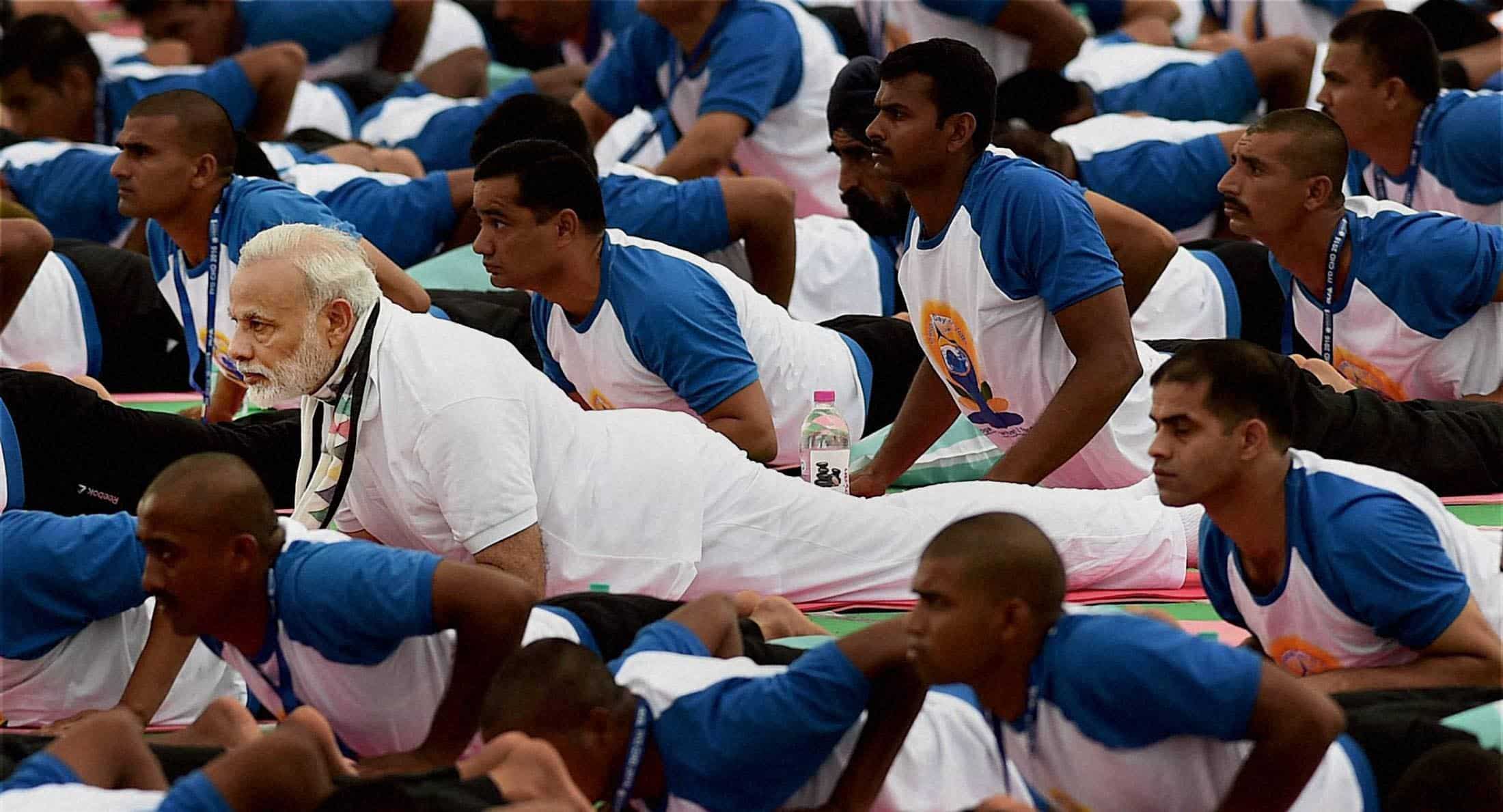 Prime Minister Narendra Modi among many yoga practitioners on second International Yoga Day celebration event. PTI