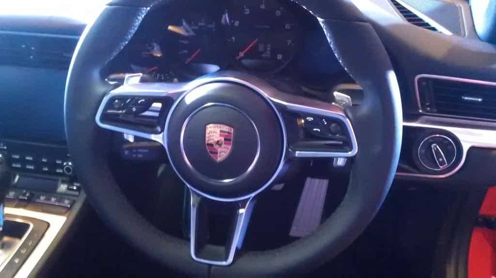 The steering wheel inside the 911 range comes from the 918 Spyder plug-in hybrid sports car by Porsche. Photo: Collin Furtado