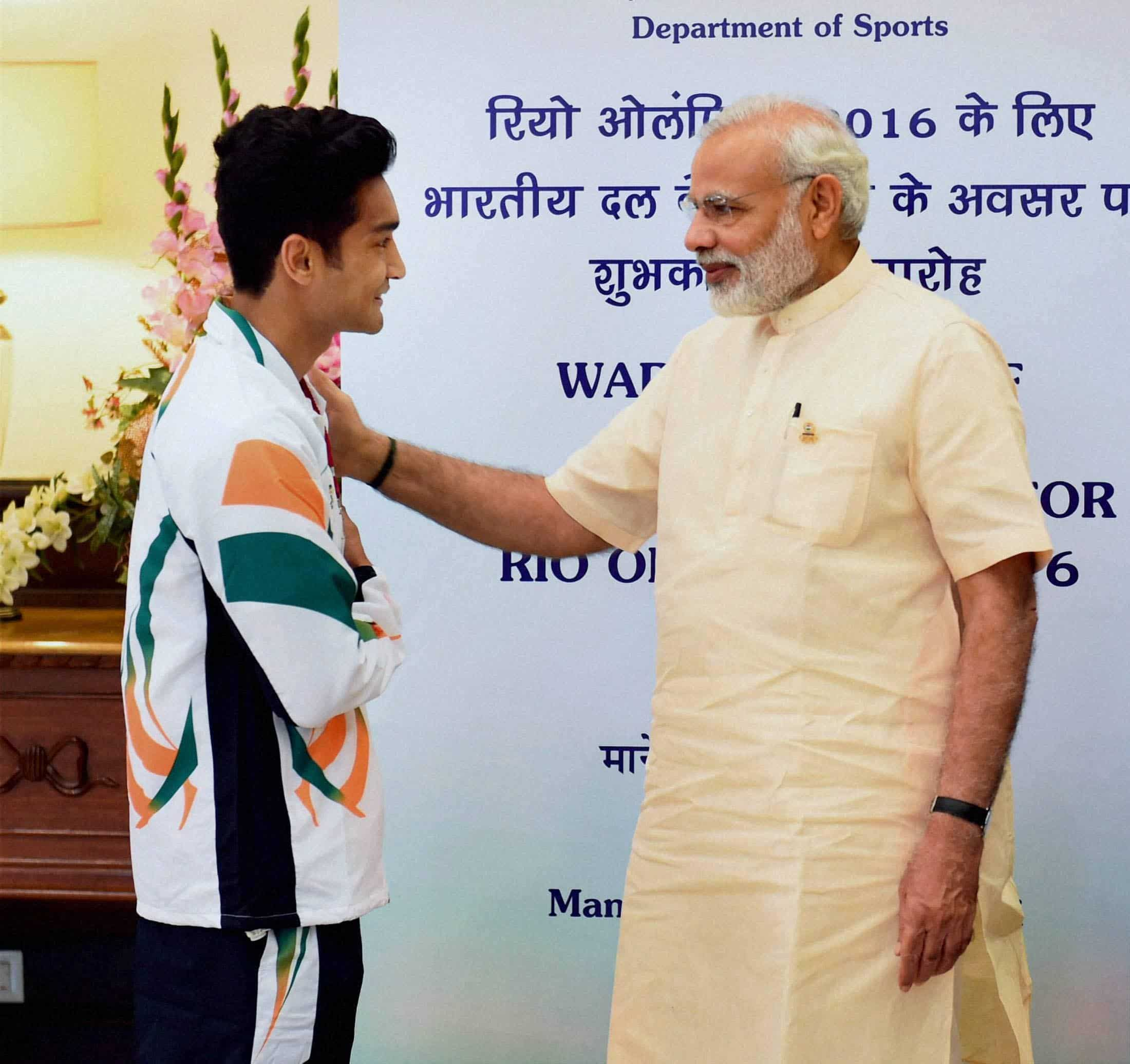 PM Modi and Indian boxer, Shiv Thapa at Manekshaw Centre. PTI