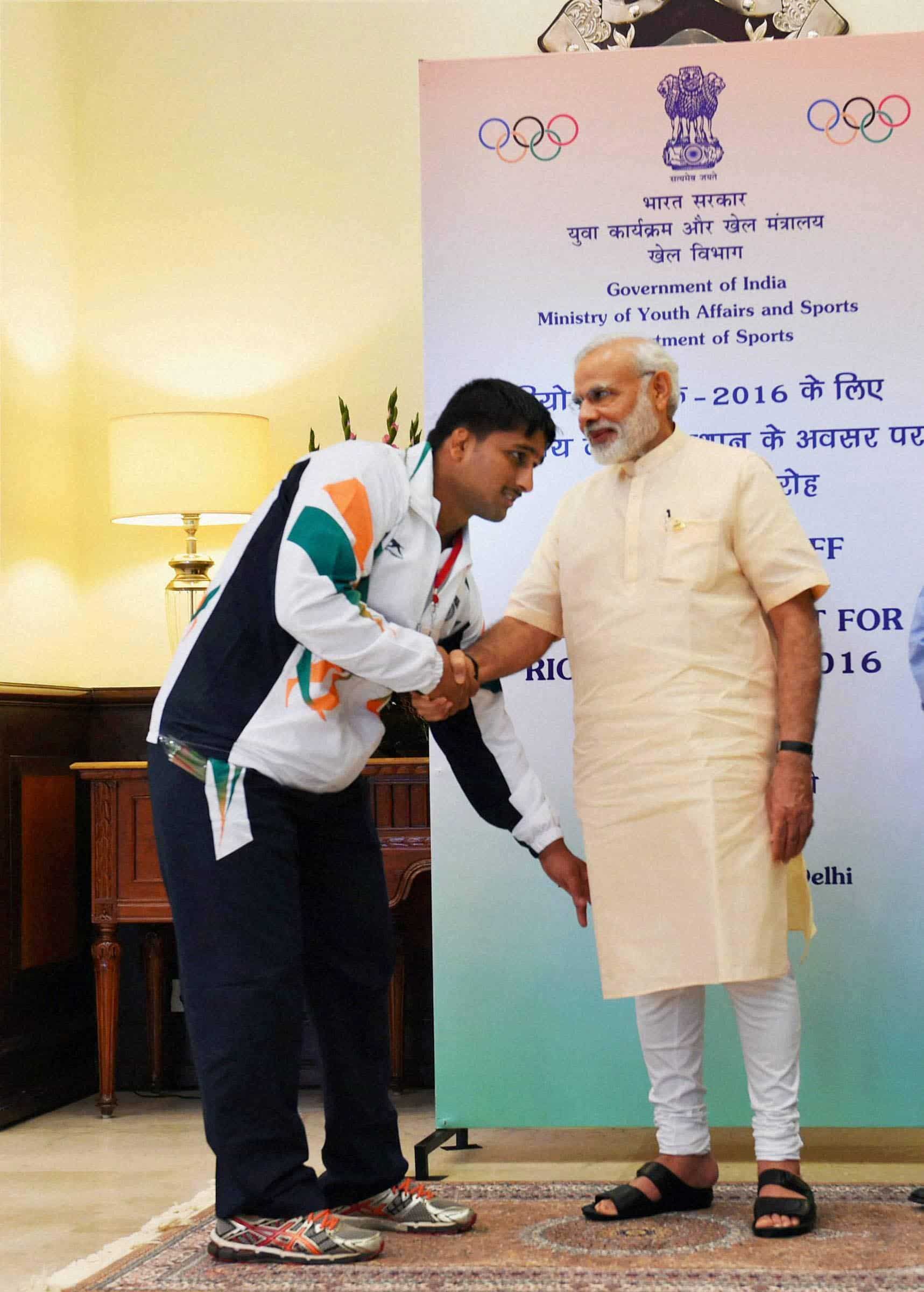 Wrestler Hardeep seeks the blessings of Prime Minister Narendra Modi at a warm send-off ceremony. PTI 