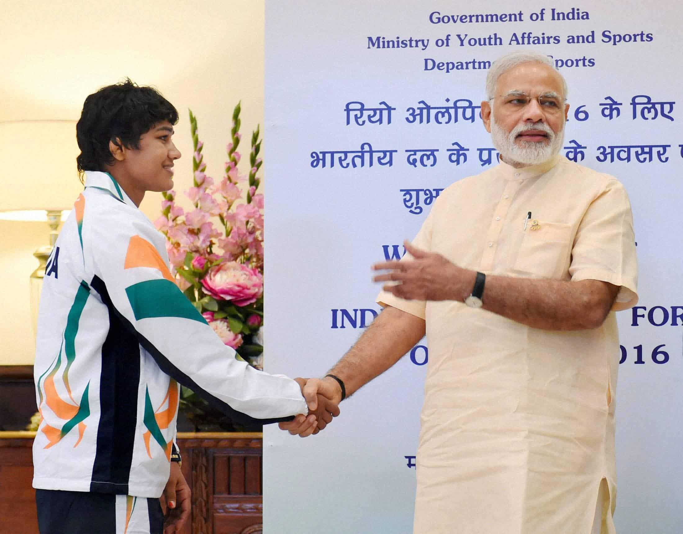 Prime Minister Narendra Modi shakes hands with wrestler Babita Kumari. PTI 