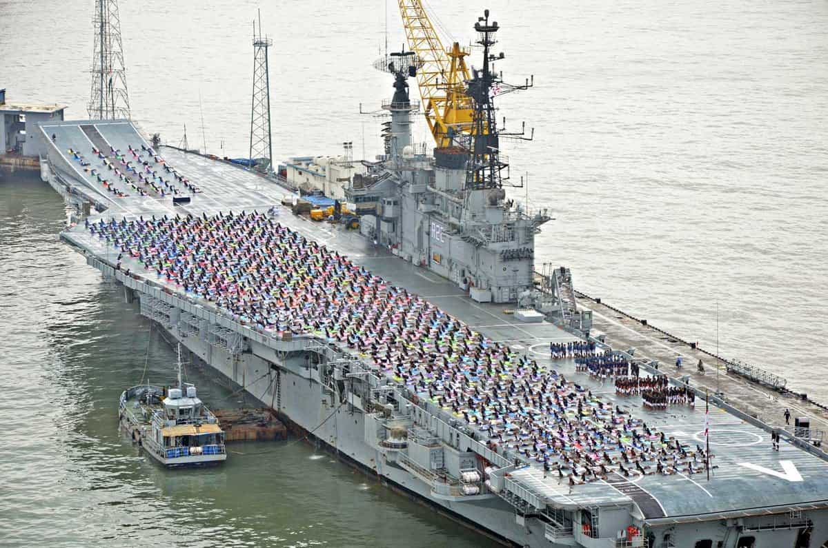 Colourful spectrum onboard the Viraat as Navy personnels practice yoga. Twitter/MoD