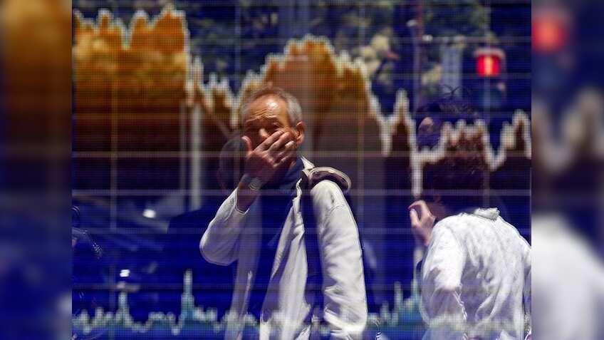 Asian stocks edge up, dollar dips as markets await Fed clues