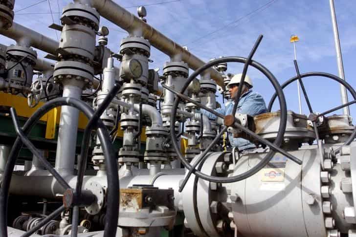 Crude oil falls towards $49 per barrel on high output, strong dollar 