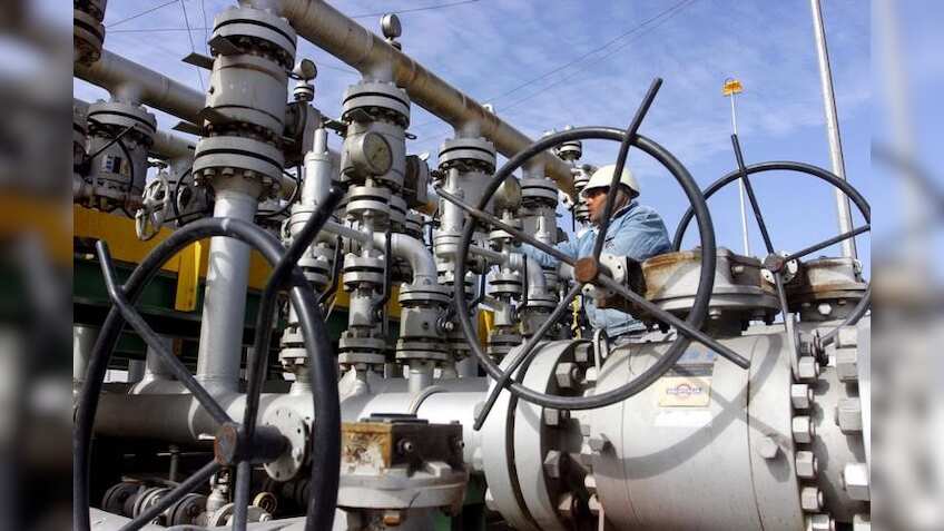Crude oil falls towards $49 per barrel on high output, strong dollar 