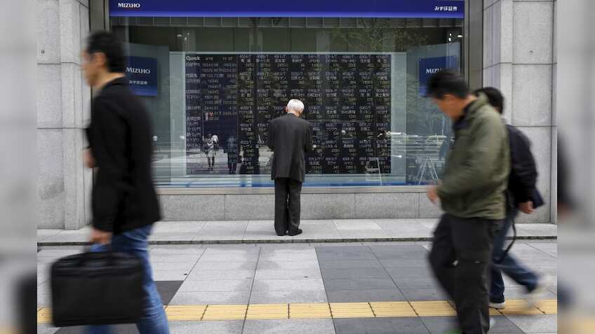 Asian stocks inch up after Wall Street's gains, oil prices slide
