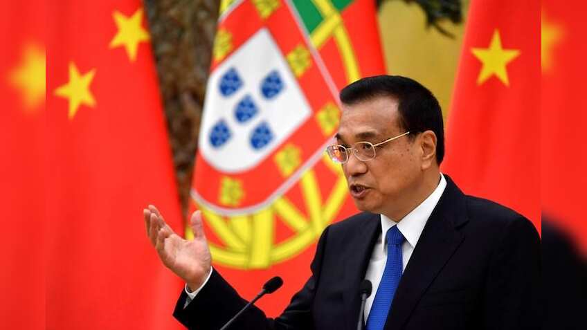 China premier says economy improving, debt risks under control