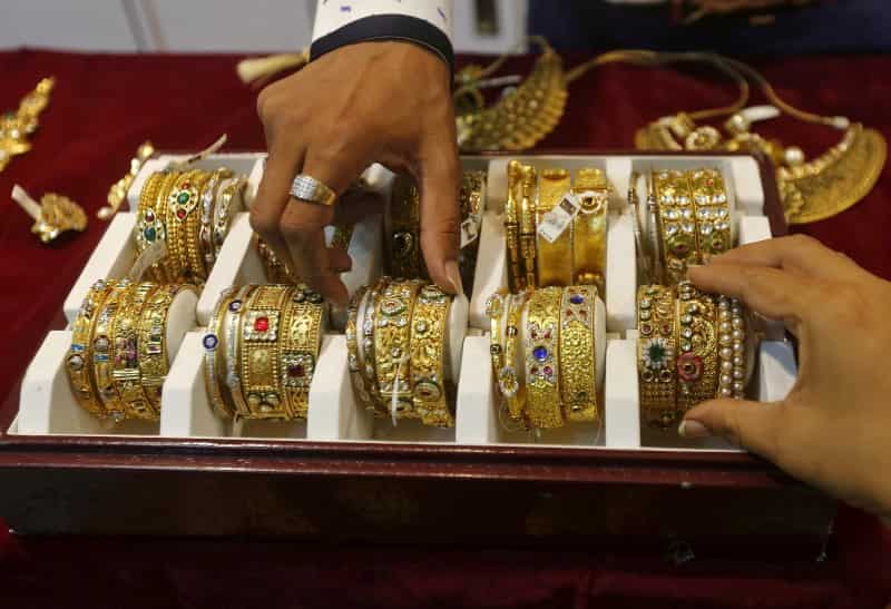 Gold slips as dollar climbs to 14-year high