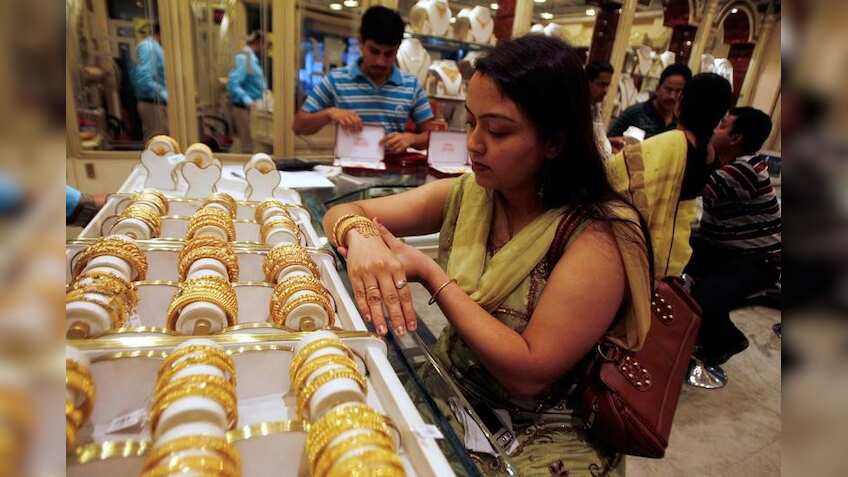 Gold edges up after falling to 10-month lows