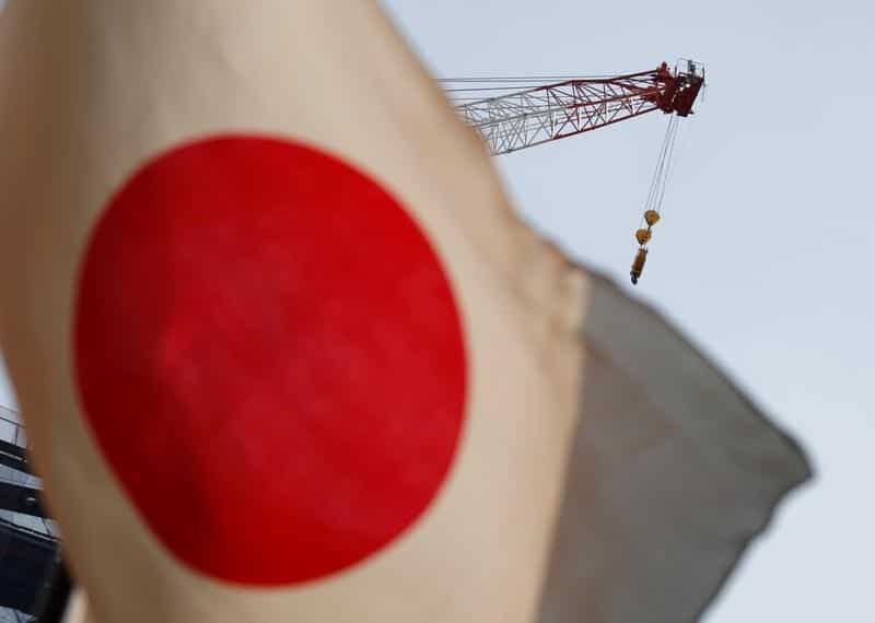 Bank of Japan keeps policy on hold, brightens view of economy