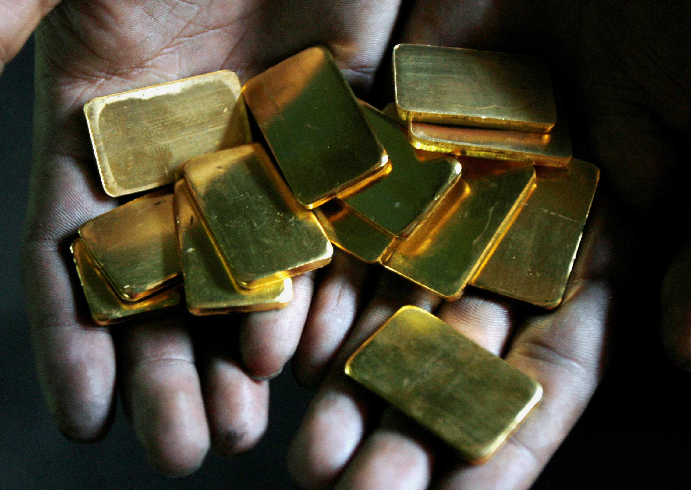 Gold retreats from five-month high as dollar rebounds