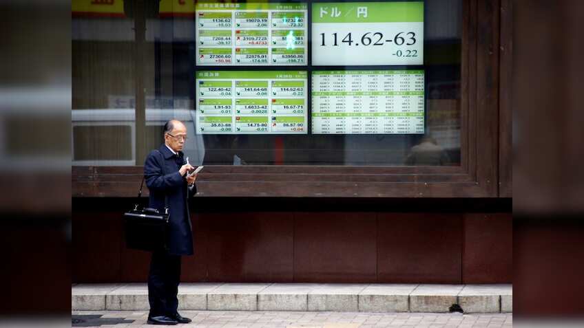 Asian shares firm, dollar and US bond yields slip after Fed