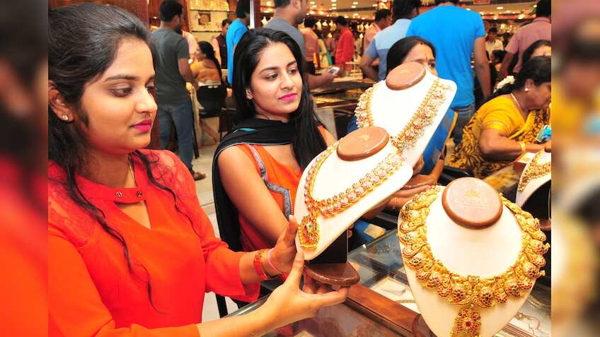 Festive cheer fails to make gold sparkle; tumbles by Rs 100 on global cues
