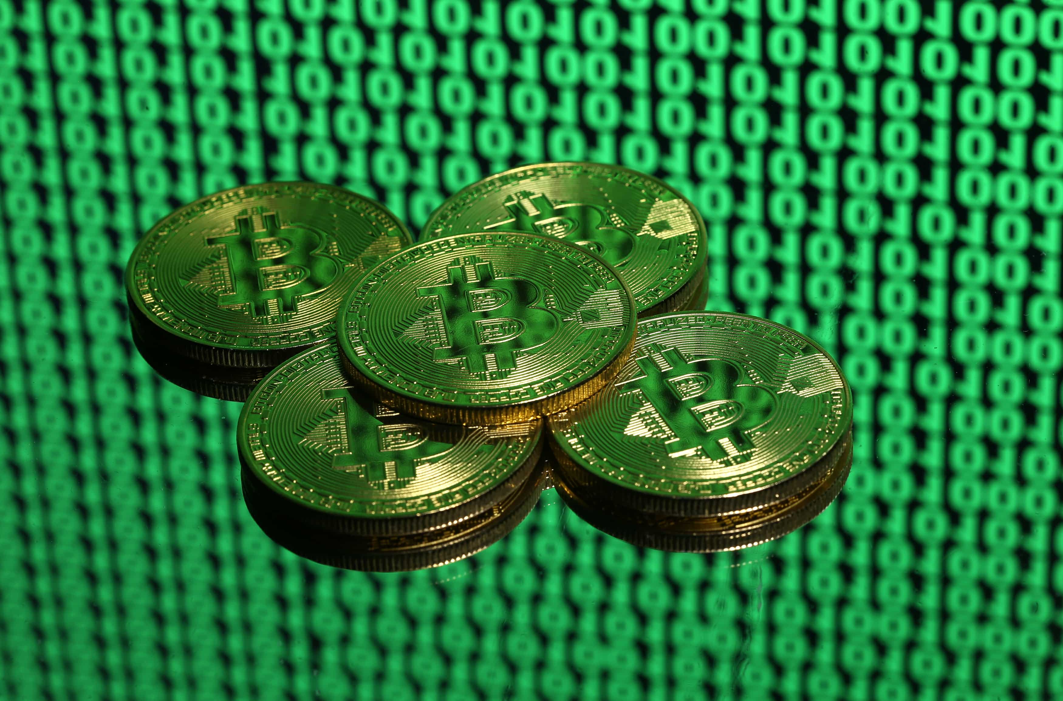 Bitcoin futures make firm debut, dollar holds gains ahead of Fed meet
