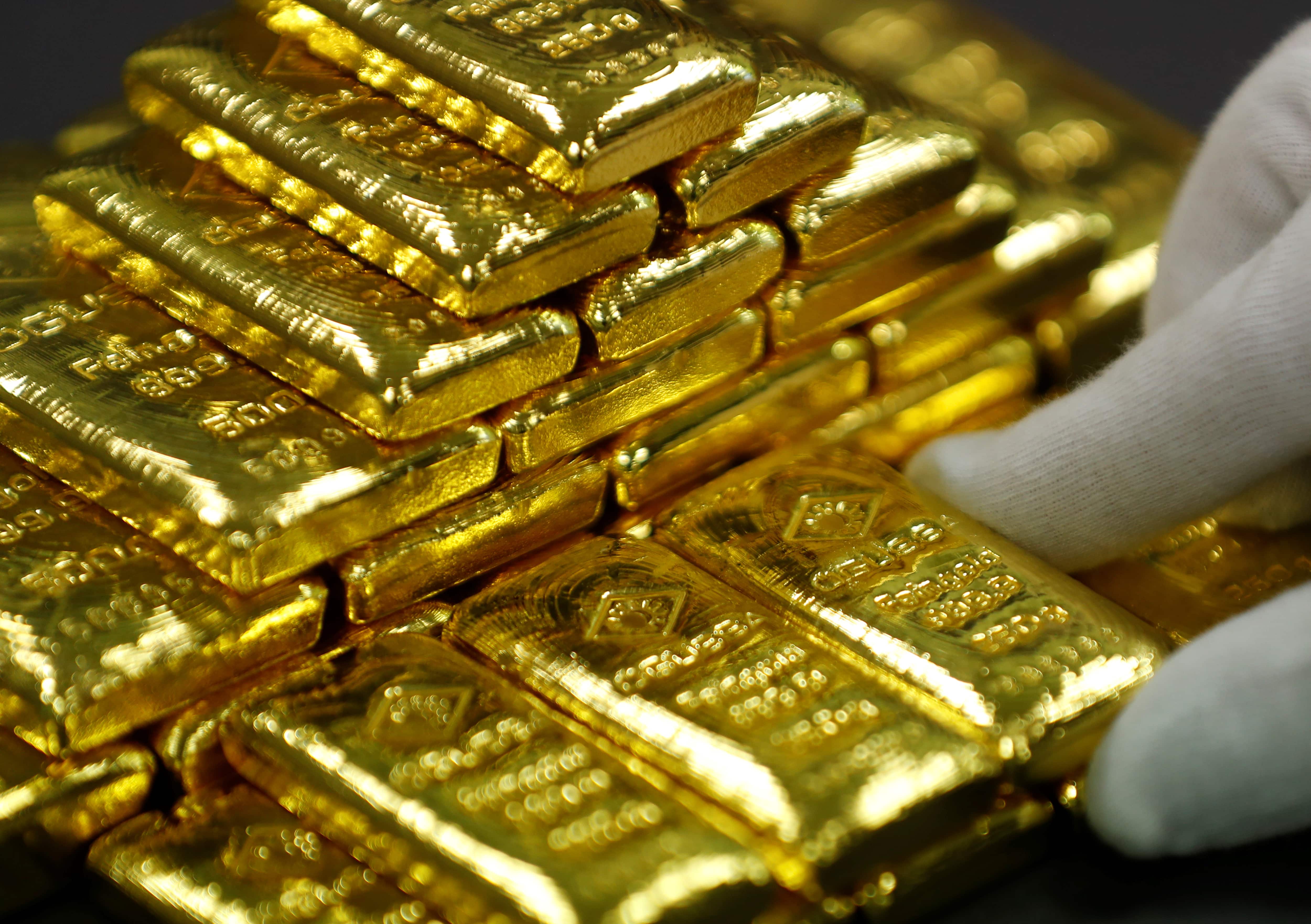 Gold up on weaker dollar, heads for fifth gain on week