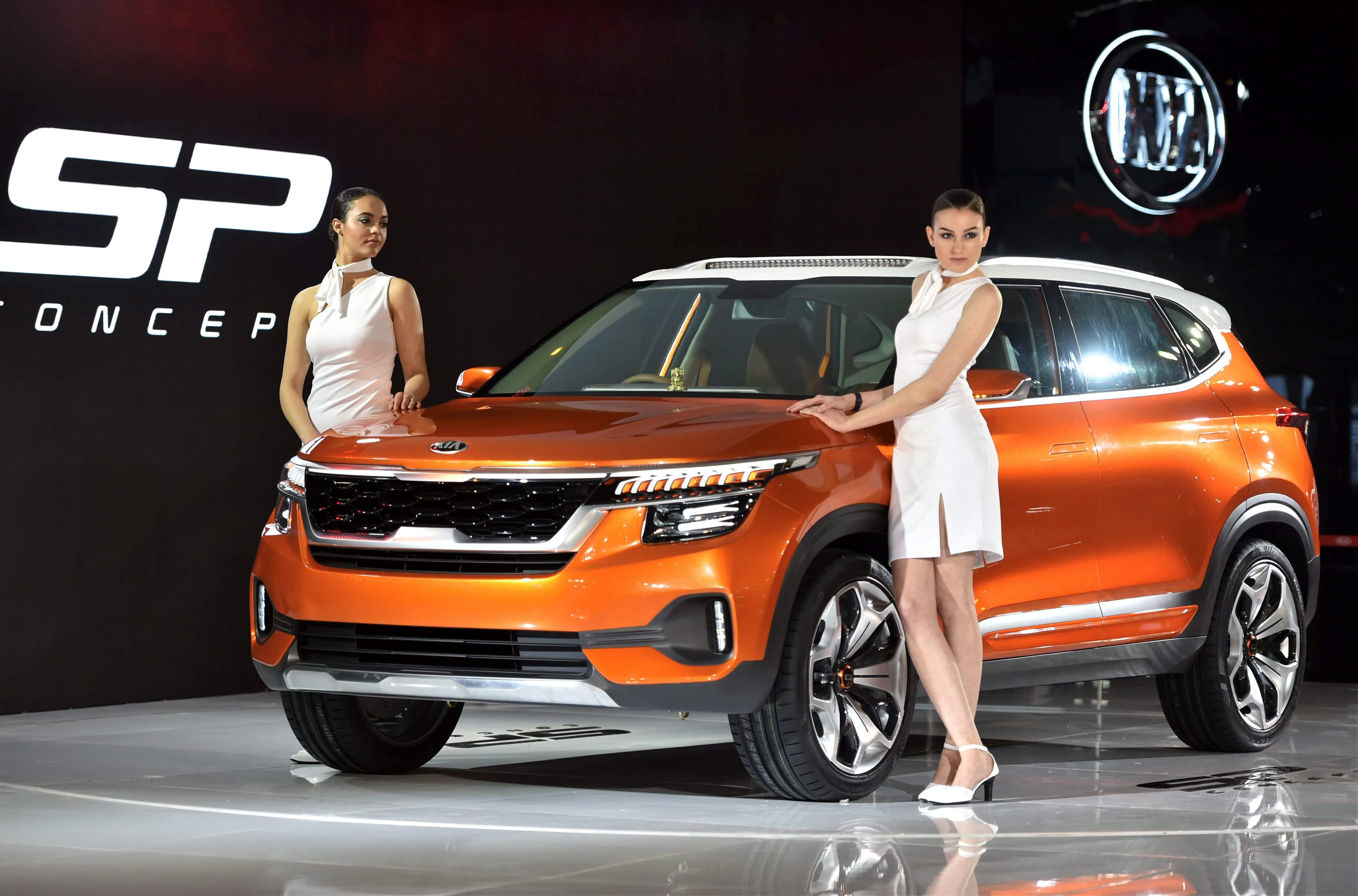 Models showcase a Kia Motors Corporation's SP Concept car at the Auto Expo 2018 in Greater Noida on Wednesday. 