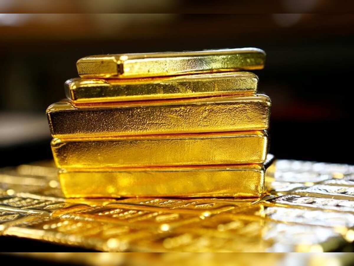 Gold hits three-week high as dollar slides to