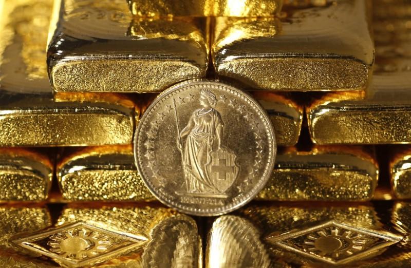 Gold prices recover from 6-month low as dollar drops; Russia buys bullion
