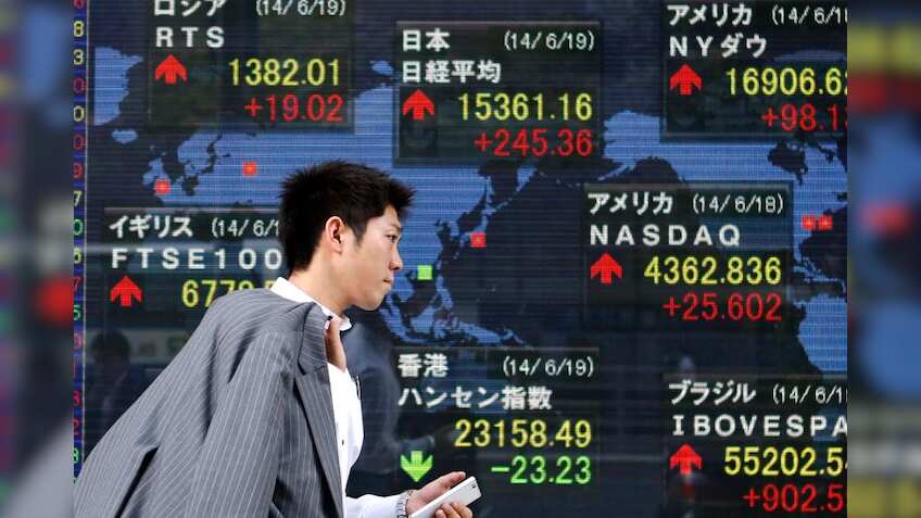 Asian shares dip as investors await China data, Fed