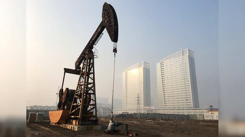 Oil prices flat as tropical storm limits output, glut forecasts weigh