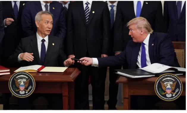 Donald Trump signs US-China trade deal with a mixture of fanfare, grievance