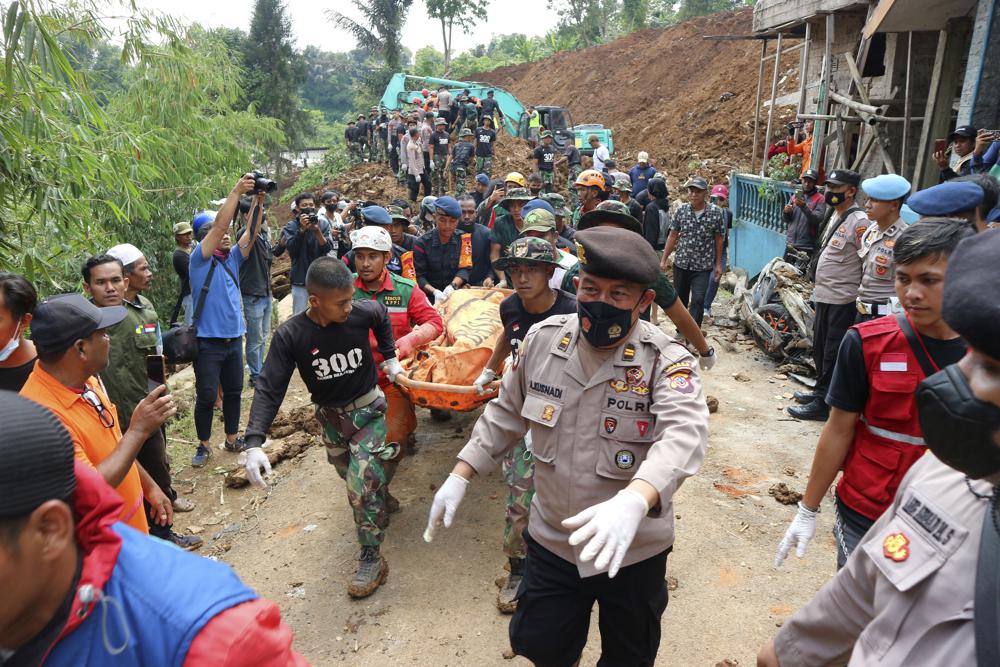 Indonesian rescuers search through the rubble of quake; 268 dead