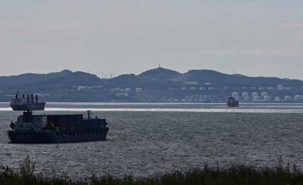 Oil rises to over  per barrel as dollar slumps on slowing inflation