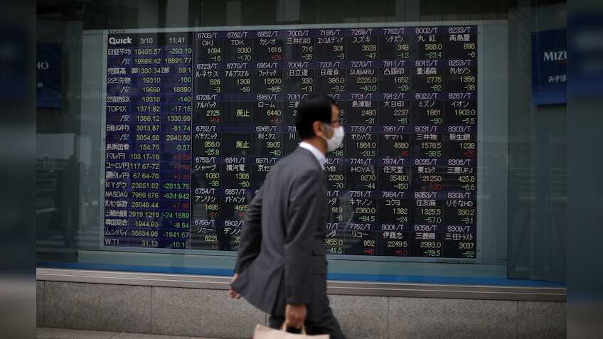 Asian stocks choppy as US inflation slows and dollar drops; Hong Kong shares down nearly 1%
