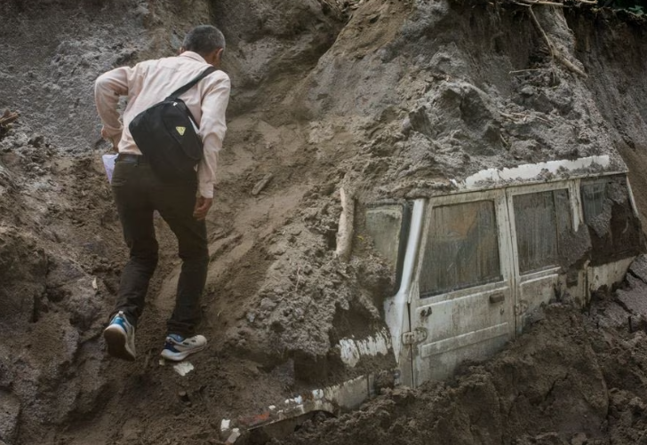 Rescuers struggle to reach flood-hit areas where over