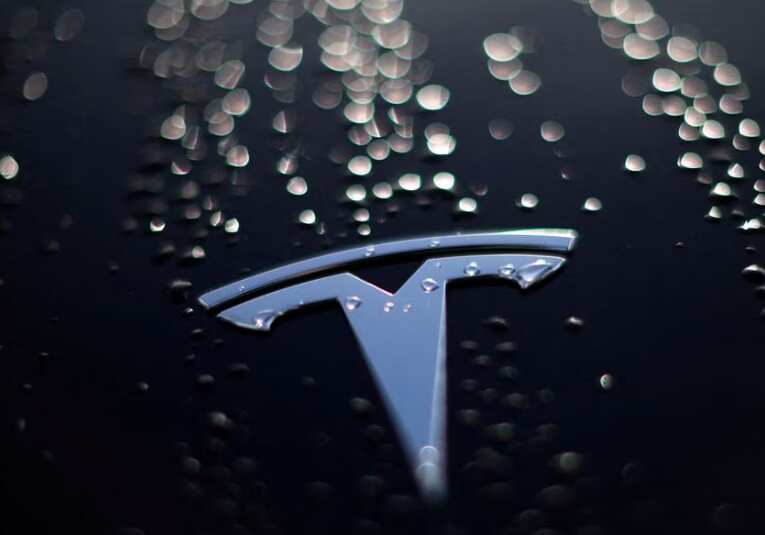 Tesla falls as production cut by battery supplier Panasonic fans EV demand fears