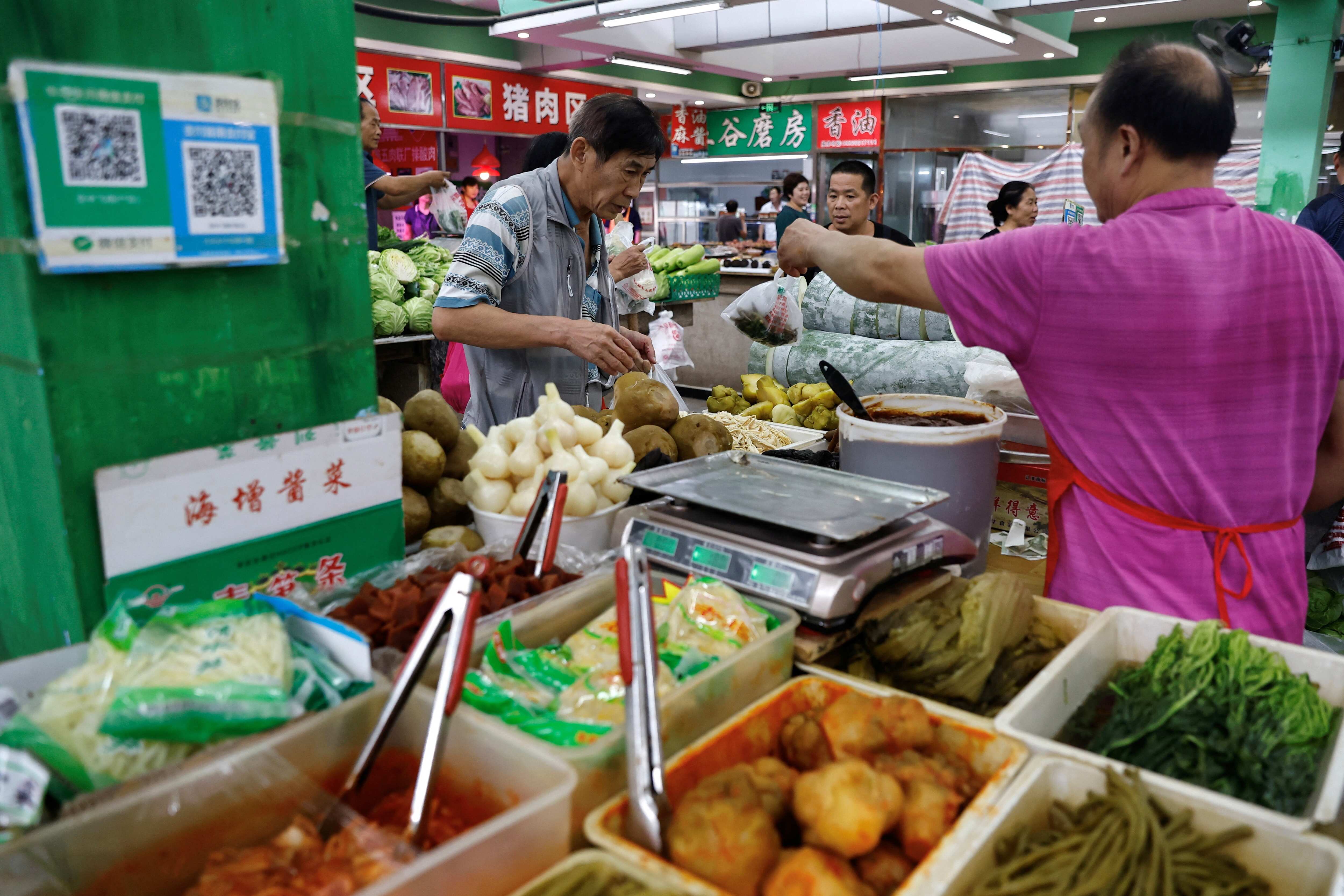 China's consumer prices dip back into decline amid limp demand