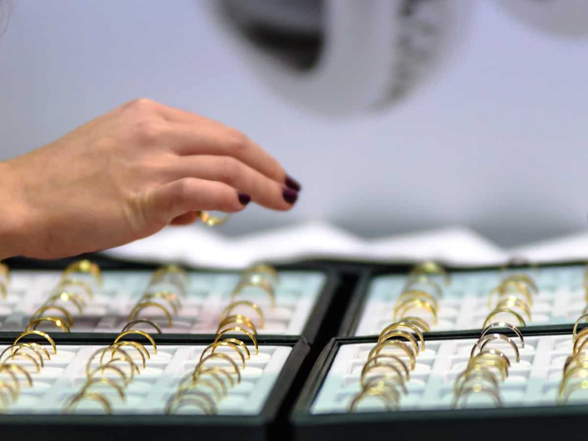 Gold hovers near record high as market focus turns to US data, Fed minutes