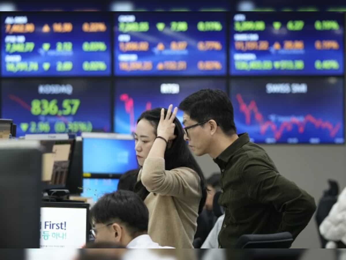 Asian market news: Stocks mostly rise, boosted by Wall Street records as Tesla zooms