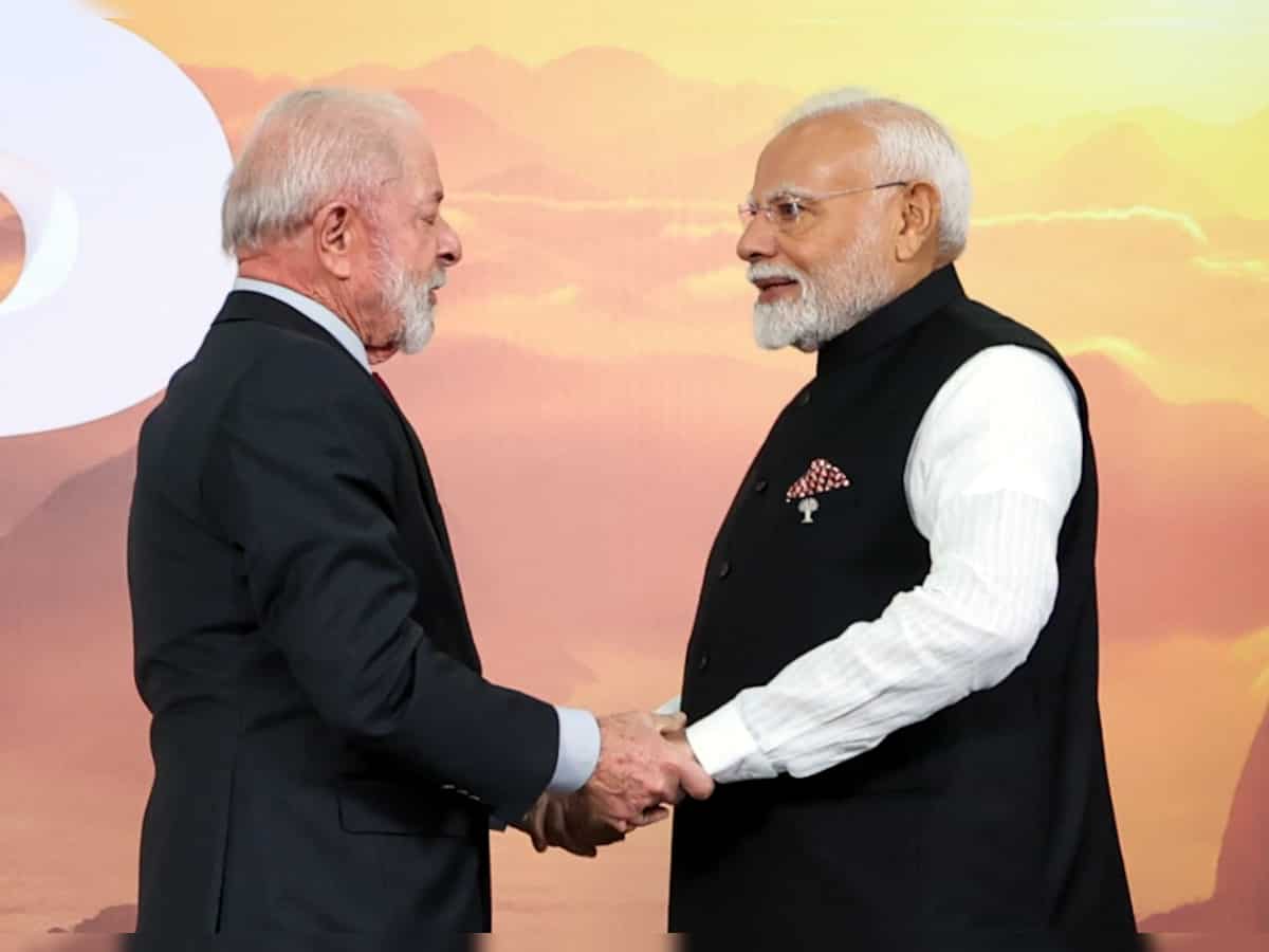 PM Narendra Modi shakes hands, shares hug with