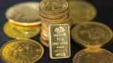 Gold edges lower, market focus turns to OPEC