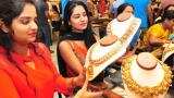 Festive cheer fails to make gold sparkle; tumbles by Rs 100 on global cues