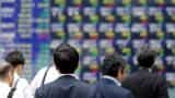 Asian shares slip as investors await US tax reforms, dollar steadies
