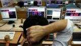 Sensex trades flat, Nifty slips below 10,700; IT stocks lead