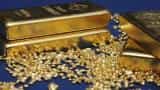 Gold up on weaker dollar, but heads for first weekly loss in six