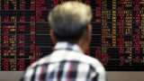 Asian markets edge lower as investors await China data