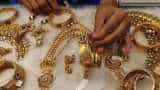 Gold prices subdued as dollar holds firm near 13-month high