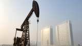 Oil prices flat as tropical storm limits output, glut forecasts weigh