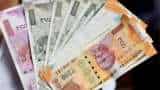 Rupee settles almost flat at 74.02 against US dollar