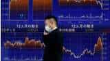Asian shares firm as Fed tempers aggressive rate hike bets