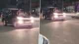 Noida Stunt Video: Noida Woman Performs Stunt By Sitting On Moving Car&#039;s Bonnet, UP Police Takes Action