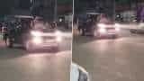 Noida Stunt Video: Noida Woman Performs Stunt By Sitting On Moving Car's Bonnet, UP Police Takes Action Noida Stunt Video: Noida Woman Performs Stunt By Sitting On Moving Car's Bonnet, UP Police Takes Action