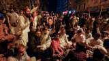 Imran Khan's party workers clash with police outside his Lahore residence to foil his arrest Imran Khan's party workers clash with police outside his Lahore residence to foil his arrest