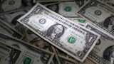 Dollar finds footing on housing data as yuan falters